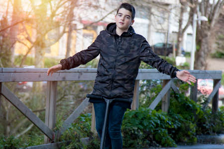 child in the street playing with the scooterの写真素材