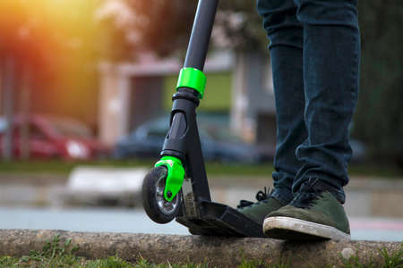 feet of the child in the scooter in the foregroundの写真素材
