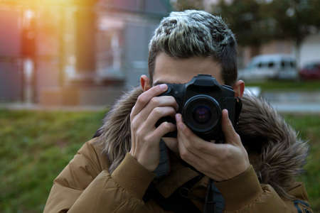 photographer, young boy teen taking pictures with the cameraの写真素材
