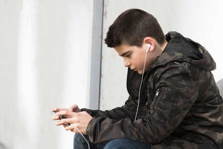 child in old school with the phone mobile to open airの写真素材