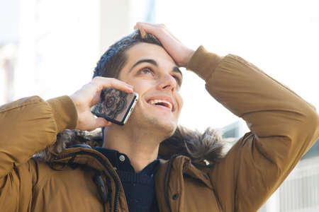 young man with the phone on the street talking aboutの写真素材