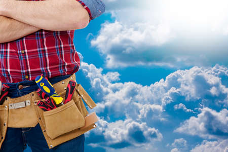 builder with the belt of tools on background to outdoorの写真素材