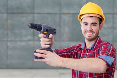 builder with the drill on outdoor background