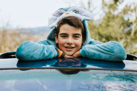 portrait of a boy disguised as a car sticking outの写真素材