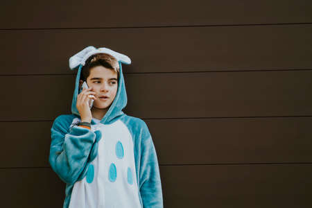 disguised as speaking by mobile phone on a background childの写真素材