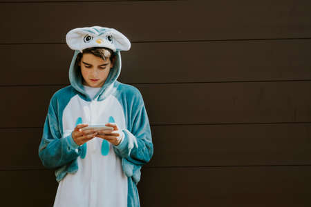 disguised by mobile phone on a background childの写真素材