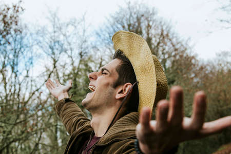 modern hipster hat and arms open to the outdoorsの写真素材