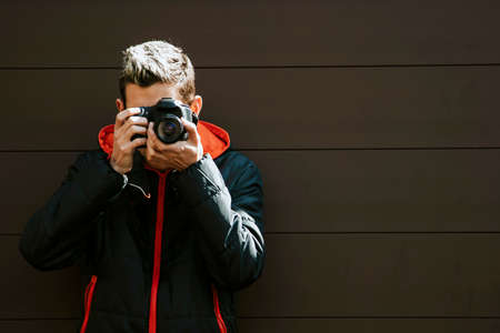 photographer with a camera taking photos on a backgroundの写真素材