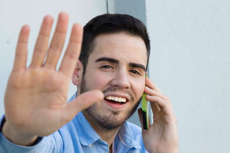 portrait of young woman with covering her hand phoneの写真素材