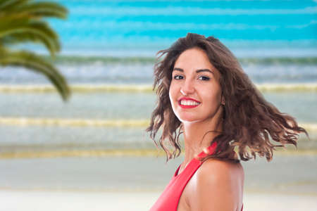 portrait of smiling young woman on the beachの写真素材