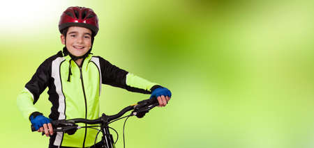 child with mountain biking, sports clothing and helmetの写真素材