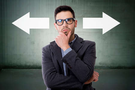 thoughtful man with the directions arrows