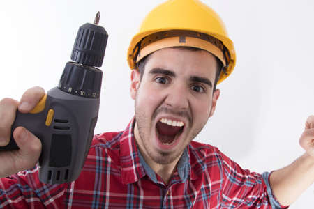 builder shouting euphoric with the drillの写真素材
