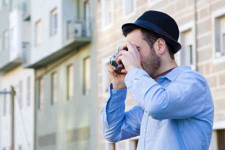 young traveller with the camera making tourism in the cityの写真素材