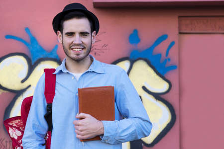 young man with the agenda, book or street city tripの写真素材