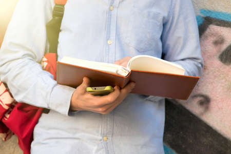 hands holding the open book