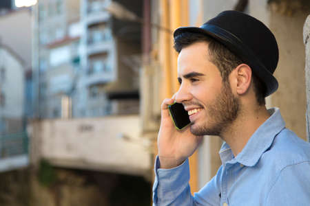 young man talking on the phone in the cityの写真素材
