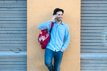 young man with mobile in the city