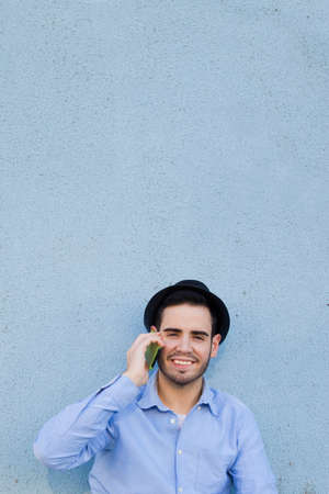 young man with the phone on the streetの写真素材