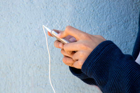 closeup of hands of the child with the mobile phone