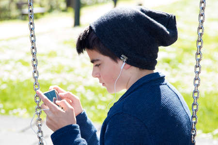 child with outdoor mobile phoneの写真素材