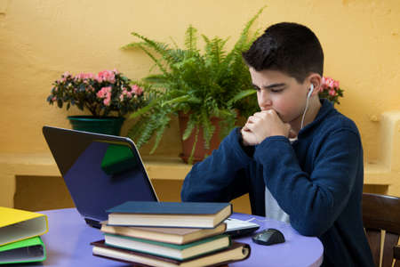 student with books and the computer