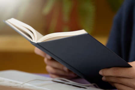 student with books and the computer