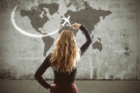 woman thinking about holiday and travel destinationの写真素材