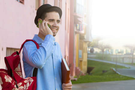 young man of style hipster fashion talking on mobile phone