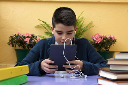 child with the tablet or the book digital, headphone