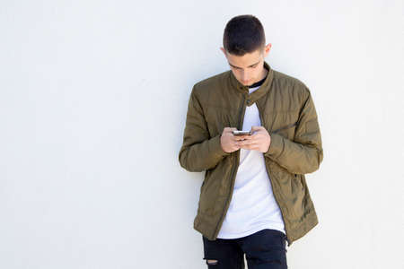 young man with mobile phone on streetの写真素材