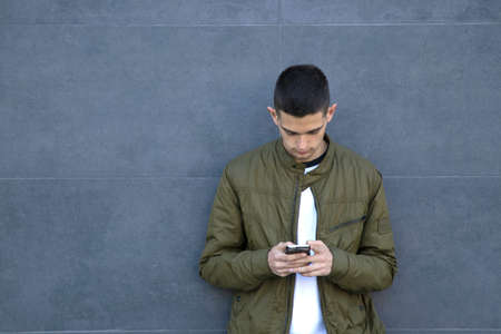 young man with mobile phone on street