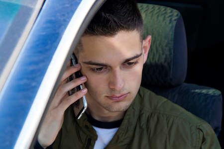 young man with the cellphone in the car