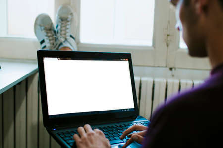 close-up of the young man with the laptop at home working