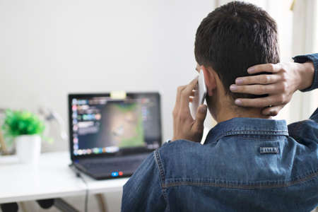 young man with the mobile phone and the laptop