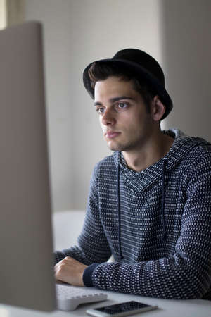 adult young working with your computer at home or in the officeの写真素材