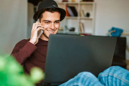 young man with the mobile phone and the laptop