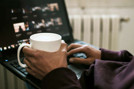 close-up of the young man with the laptop at home workingの写真素材