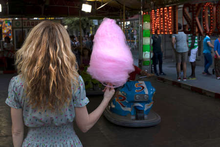 young woman with cotton candy at the partyの写真素材