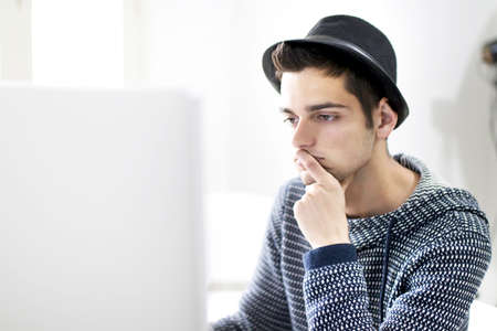 Young man working with computer at home or in the office