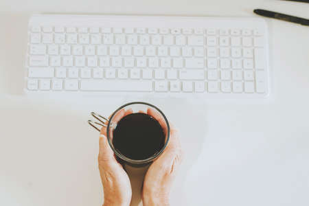 hands with coffee cup on deskの写真素材