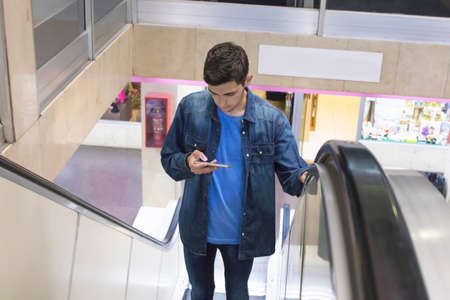 teenager with the mobile at the mallの写真素材