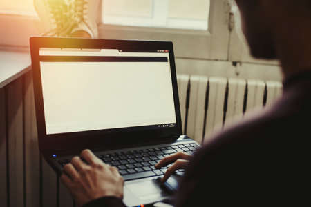 young man relaxed working with the laptopの写真素材