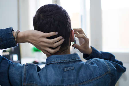 freelance speaking by phone with the computer in the officeの写真素材