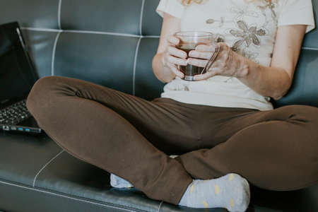 hands of woman with black coffee mugの写真素材