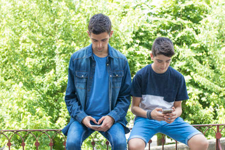 young people with the phone phones on the streetの写真素材