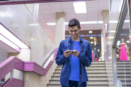 teenager with the mobile at the mallの写真素材