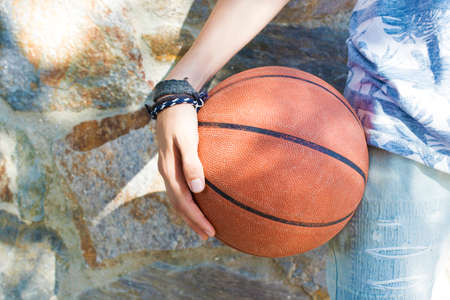Closeup of hands with basketball ball