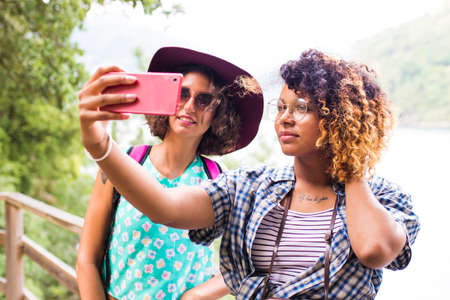 friends with the phone for travel and excursionの写真素材