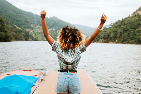 girl at the pier enjoying with arms upの写真素材